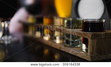 Multicolored Transparent Cocktails, A Set Of Shots In One Row, Six Servings On A Wooden Stand, Subst