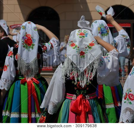 Lowicz / Poland - June 20 2019: Girls In Colorful Folk Costumes From Lowicz Region While Join Annual