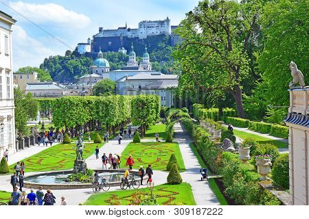 Salzburg, Austria - May 23, 2018 : People Walk Among Flower Beds In The Mirabell Park In Salzburg, O