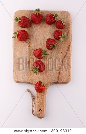 Strawberry Question Mark On A Blackboard. Macro Shooting