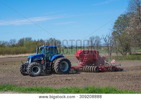 Mon Denmark - May 5. 2018: New Holland Tractor With A Seeding Machine