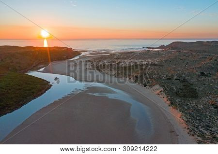 Aerial from Amoreira beach on the westcoast in Portugal at sunset