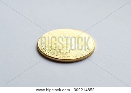 Golden Bitcoin On White Background. Concept Mining. Copyspace