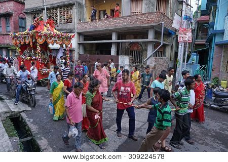 Howrah, West Bengal , India - July 22th 2018 : Young Bengali Hindu Devotees Dragging Holy Rope To Pu