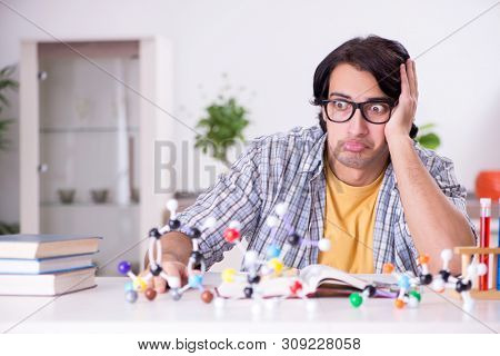 Young student physicist preparing for exam at home    