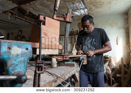 Gianyar,bali/indonesia-may 30 2019: A Guitar Craftsman Is Measuring And Make Sure It Is A Precision
