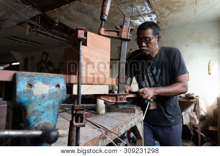 Gianyar,bali/indonesia-may 30 2019: A Guitar Craftsman Is Making Classical Guitars Made Of Wood In A