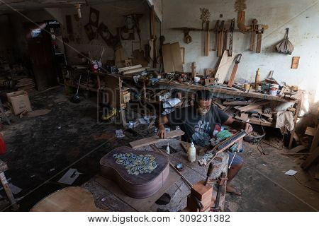 Gianyar,bali/indonesia-may 30 2019: A Guitar Craftsman Is Measuring And Make Sure It Is A Precision