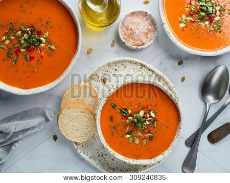 Gaspacho Soup On White Marble Tabletop. Three Bowls Of Traditional Spanish Cold Soup Puree Gaspacho 