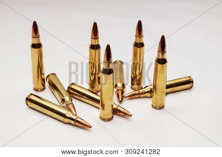 Ten 223 Caliber Bullets On A White Background