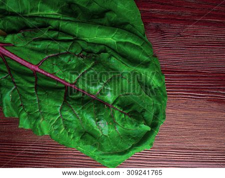 Fresh Raw Leaves Of Chard, Leaf Beets, Mangold, Swiss Chard On A Wooden Table, Copy Space
