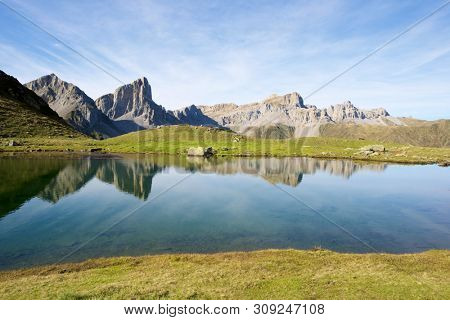 Peaks reflected in Ansabere Lake. Lescun Cirque. Aspe Valley, Pyrenees, France.