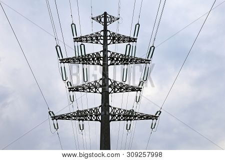 High Voltage Power Line Supports With Electrical Wires On Cloudy Sky. Electricity Transmission Lines