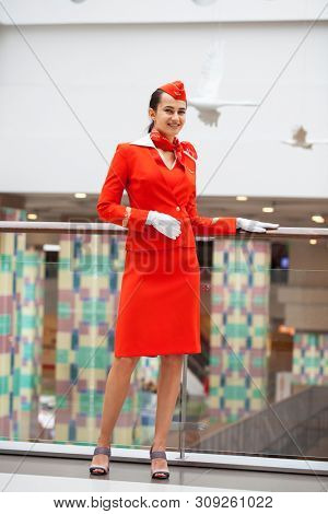 RUSSIA, MOSCOW: 28 JUNE 2019. Beautiful stewardess dressed in official red uniform of Aeroflot Airlines on airport