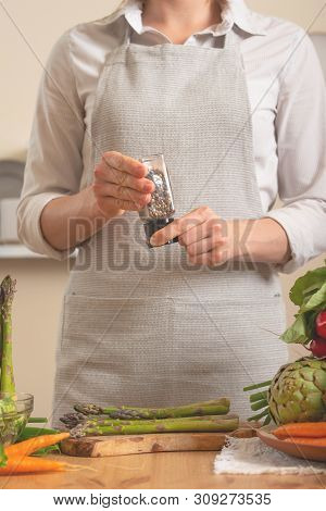 Chef Peppers Asparagus, With Vegetables On A Light Background. The Concept Of Losing Healthy And Hea
