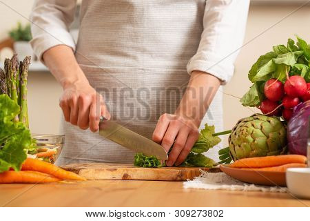 Chef Cuts Fresh Green Salad. The Concept Of Losing Healthy And Wholesome Food, Detox, Vegan Eating,