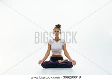Sporty Young Woman Doing Yoga Practice Isolated On White Studio Background. Fit Flexible Female Mode