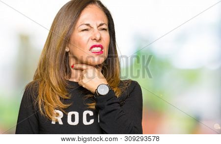 Beautiful middle age woman wearing rock and roll sweater Touching painful neck, sore throat for flu, clod and infection