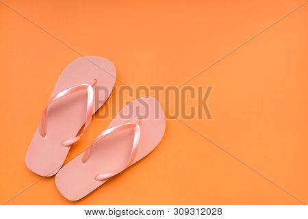 Living Coral Flip Flops On A Coral Background. Color Of The Year 2019. Place For Text.