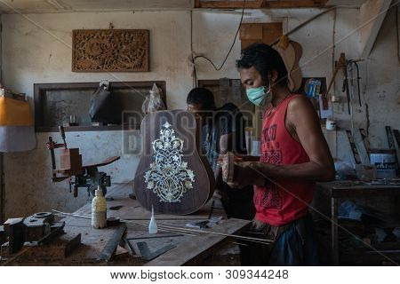 Gianyar,bali/indonesia-may 30 2019: A Guitar Craftsman Is Measuring And Make Sure It Is Precision In