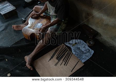 Gianyar,bali/indonesia-may 30 2019: A Guitar Craftsman Are Carving A Classical Guitars Made From Woo