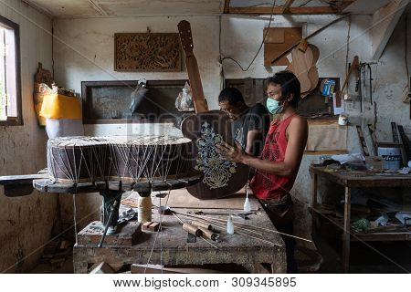 Gianyar,bali/indonesia-may 30 2019: A Guitar Craftsman Is Measuring And Make Sure It Is Precision In