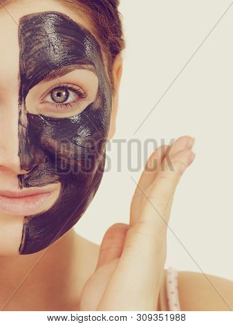 Woman With Clay Carbo Detox Black Mask On Her Face. Girl Taking Care Of Oily Skin Complexion. Beauty