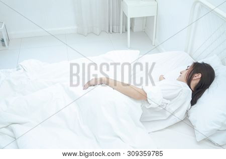 Women Wearing White Pajamas Are Resting.