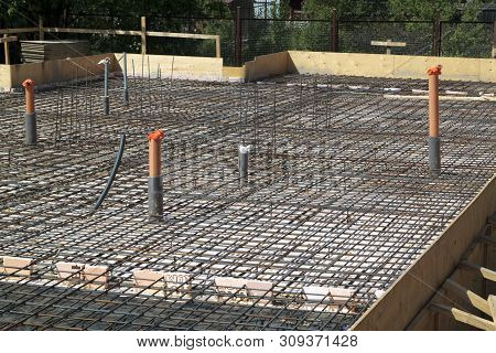Reinforcement Of Concrete With Metal Rods Connected By Wire. Preparation For Pouring The Foundation
