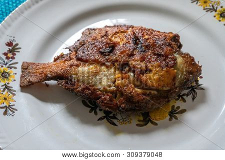A Fried Pomfret Fish Served On A White Decorated Platter, Spicy Indian Food. Pomfrets Are Perciform 