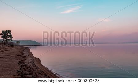 Shoreline And Reflection Of Pink Clouds On A Lake. Saylorville Lake, Near Polk City, Iowa, Usa. Blue