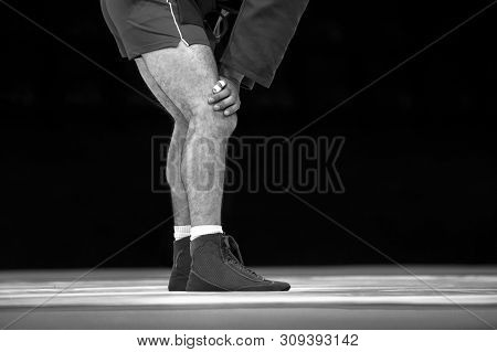 Men Wrestling On A Yellow Wrestling Carpet In The Gym