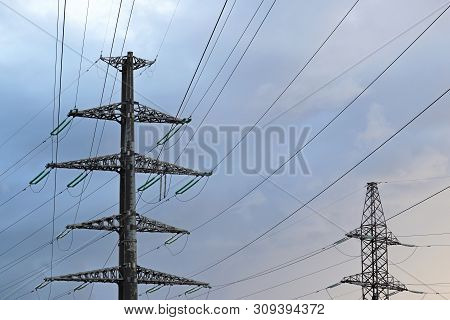 High Voltage Towers With Electrical Wires On Cloudy Sky Background. Electricity Transmission Lines, 