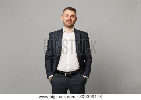Handsome Successful Confident Young Business Man In Classic Black Suit Shirt Posing Isolated On Grey