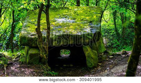 A Magic Dolmen Or Table-stone Covered By Moss In Russian Mountain Forest.