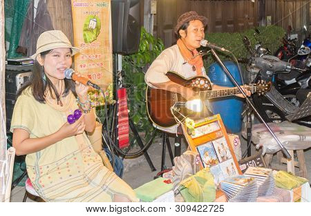 Pai, Thailand - December 10th 2014: Singer And Musician Selling Discs On The Night Market. The Town 