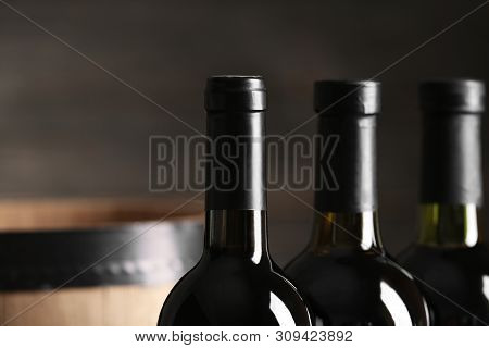 Bottles Of Tasty Wine On Dark Background, Closeup