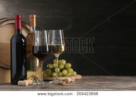 Composition With Glasses And Bottles Of Different Wine On Wooden Table. Space For Text