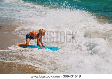 Happy Boy Enjoy Surfing At Sea, Kids Play With Water On Vacaton