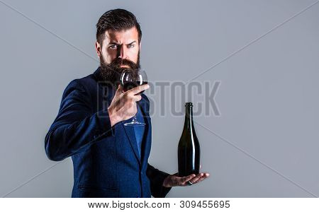 Man Holding Bottle With Champagne, Wine. Bottle, Red Wine Glass. Beard Man, Bearded, Sommelier, Tast