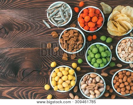 Assortment Of Different Snack For Beer, Wine, Party. Peanuts In Coconut Glaze, Green Vasabi, Red Spi