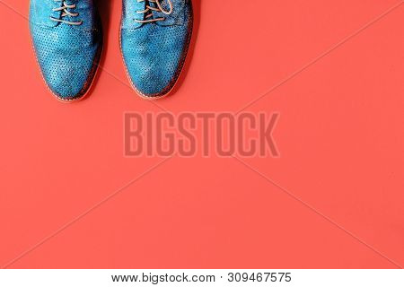 Pair Of Shiny Gradient Blue Shoes On Trendy Coral Color Background. Minimalistic Flat Lay With Copy 