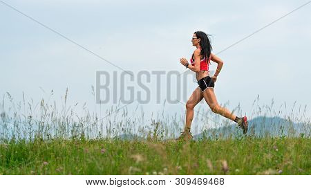 Woman Runner During The Preparation Of A Long Distance Trail