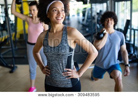 Happy Gorup Of Healthy People Training In Gym