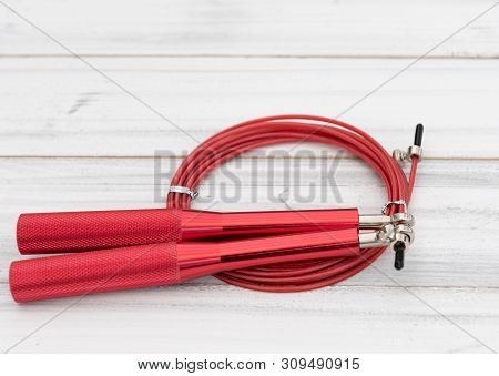 Modern Red Jump Rope On White Wooden Background,flat Lay