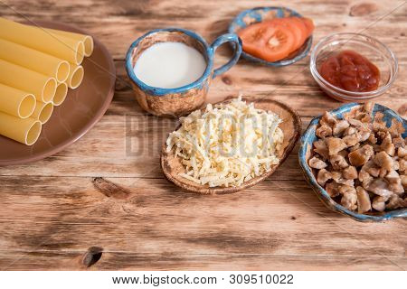 Italian Food Concept. Ingredients For Cooking Pasta. Dry Cannelloni Pasta, Cherry Tomatoes, Fresh Ba