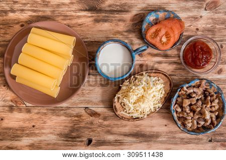Italian Food Concept. Ingredients For Cooking Pasta. Dry Cannelloni Pasta, Cherry Tomatoes, Fresh Ba