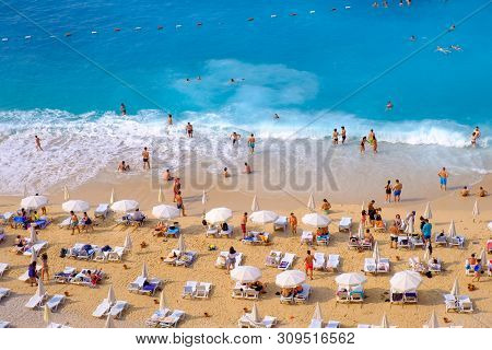 Kaputas Beach, Qas, Turkey, May 14, 2019: People Enjoy Relaxation, Swimming And Sunbathing On The Fa