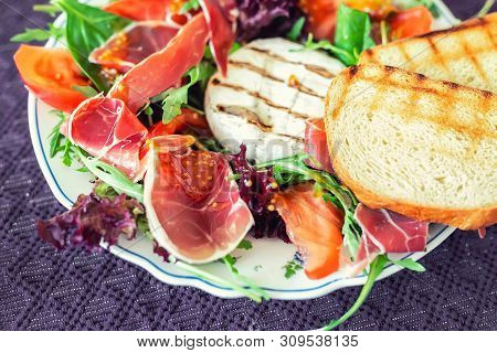 Tasty Mixed Salad Dish With Grilled Camembert Cheese, Prosciutto Ham, Organic Tomato And Fresh Green