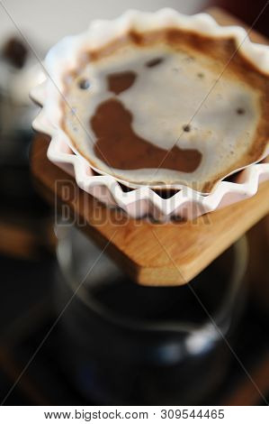 Brewing Coffee In Pink Ceramic Origami Dripper. Top View. On Wooden Coffee Stand. Close Up. Alternat